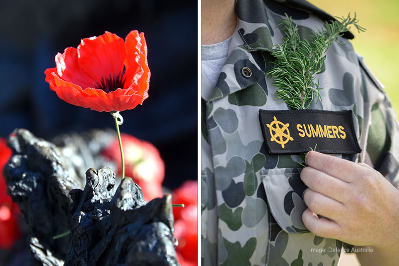 Red remembrance poppy beside a memorial sculpture and rosemary pinned to an Australian Defence Force uniform.